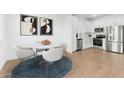 Open-concept kitchen & dining area with stainless steel appliances at 2828 W Eagle Talon Rd, Phoenix, AZ 85085