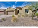 Inviting exterior featuring drought tolerant landscaping and a brick paver driveway at 32366 N 133Rd Ln, Peoria, AZ 85383