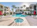 Inviting community pool area featuring a hot tub and plenty of seating, perfect for entertaining and relaxation at 5303 N 7Th St # 109, Phoenix, AZ 85014