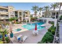 Resort-style community pool area with comfortable seating, palm trees, and well-maintained grounds at 5303 N 7Th St # 109, Phoenix, AZ 85014