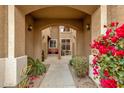Inviting entryway with an arched entrance, desert landscaping, and a charming gate leading to a cozy courtyard at 5415 E Mckellips Rd # 24, Mesa, AZ 85215