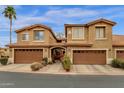 Charming two-story townhome with a desert landscape, covered entryway, and attached two-car garage, perfect for comfortable living at 5415 E Mckellips Rd # 24, Mesa, AZ 85215