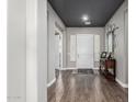 Inviting foyer with dark hardwood floors, neutral walls, and a decorative mirror next to the front door at 5810 E Calle Marita E --, Cave Creek, AZ 85331