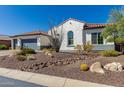 A landscaped front yard with desert foliage with a home that has a three-car garage and a desert-style roof at 5810 E Calle Marita E --, Cave Creek, AZ 85331