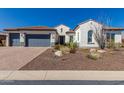 Charming single-story home with a well-manicured front yard featuring desert landscaping and a three-car garage at 5810 E Calle Marita E --, Cave Creek, AZ 85331