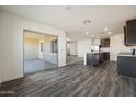 Open floorplan featuring wood flooring, sliding glass doors, and a kitchen with stainless appliances at 618 W Pintail Dr, Casa Grande, AZ 85122
