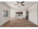 Open-concept living area with a kitchen featuring an island, stainless appliances, and granite countertops at 619 W Pintail Dr, Casa Grande, AZ 85122
