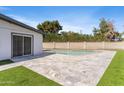 Backyard area boasts stone tile, artificial grass accents, and partial view of the pool at 6239 N 20Th Dr, Phoenix, AZ 85015