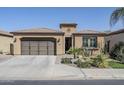 Charming single-story home with desert landscaping, a two-car garage, and a tile roof at 830 E Garden Basket Dr, Queen Creek, AZ 85140
