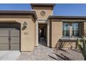 Inviting front entrance featuring a brick pathway and decorative architectural details at 830 E Garden Basket Dr, Queen Creek, AZ 85140
