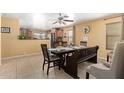 Cozy dining area with a wooden table and seating for six, plus a ceiling fan at 8520 E Laguna Azul Ave, Mesa, AZ 85209
