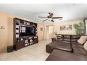 Inviting living room with tile floors, a media center and a comfortable sectional sofa at 8520 E Laguna Azul Ave, Mesa, AZ 85209