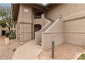 Condominium unit with private entrance and well-manicured desert landscaping, displaying a clean stucco facade at 9710 N 94Th Pl # 216, Scottsdale, AZ 85258