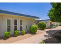 A serene exterior view showcasing desert landscaping and a well-maintained community at 10859 W Coggins Dr, Sun City, AZ 85351
