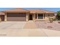 Single-story home featuring a well-maintained front yard and an attached two-car garage at 10918 E Oro Ave, Mesa, AZ 85212