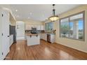 Eat-in kitchen with white cabinets, butcher block island, stainless appliances and large windows with natural light at 11263 S Oakwood Dr, Goodyear, AZ 85338