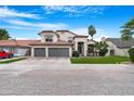 Two-story stucco home featuring a tile roof, well-manicured lawn, and a spacious three-car garage at 1225 E Sea Gull Dr, Gilbert, AZ 85234