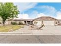 Beautiful single-story home displaying stone accents, a three-car garage, and xeriscaped front yard at 13516 W Windsor Blvd, Litchfield Park, AZ 85340
