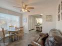 Cozy dining area with a ceiling fan, adjacent to the living area, perfect for Gathering meals at 1527 E Garnet Ave, Mesa, AZ 85204