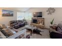 Comfortable living room with a brick fireplace, cozy seating, and lots of natural light at 1527 E Garnet Ave, Mesa, AZ 85204