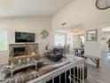 Spacious living room featuring a stone fireplace, comfortable seating, and an open floor plan at 1527 E Garnet Ave, Mesa, AZ 85204