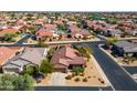 Aerial view of a single-story home with a well-manicured yard and a two-car garage in a residential area at 15900 W Autumn Cir, Surprise, AZ 85374