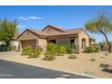 Charming single-story home with a well-manicured yard and a two-car garage on a sunny day at 15900 W Autumn Cir, Surprise, AZ 85374