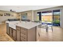 Open kitchen and dining area with a center island, sink, and views of the backyard at 18902 W Clinton St, Surprise, AZ 85388