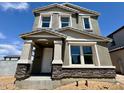 Beautiful two-story home with stone accents and neutral stucco under a brilliant blue sky at 1978 W Lariat Ln, Phoenix, AZ 85085