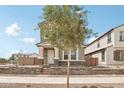 Inviting two-story home showcasing a landscaped front yard and a classic white front door at 1978 W Lariat Ln, Phoenix, AZ 85085