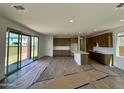 Spacious living room and kitchen area with access to the outdoor space through sliding glass doors at 1978 W Lariat Ln, Phoenix, AZ 85085