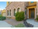 Close-up of stone archways and manicured landscaping enhance the curb appeal of this home at 20750 N 87Th St # 2074, Scottsdale, AZ 85255