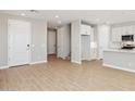 Open-concept living room with neutral paint, tile floors, and white trim at 21068 N 58Th St, Phoenix, AZ 85054
