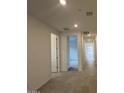 Bright hallway with recessed lighting and neutral colored walls leading to other rooms in the home at 25170 W Wayland Dr, Buckeye, AZ 85326