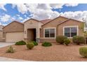 Charming single-story home featuring desert landscaping, a neutral color palette, and a two-car garage at 30303 W Whitton Ave, Buckeye, AZ 85396