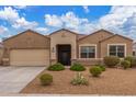 Charming single-story home featuring desert landscaping, a neutral color palette, and a two-car garage at 30303 W Whitton Ave, Buckeye, AZ 85396