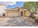 Tan single-story home showcasing a tile roof, arched entryway, and desert landscaping at 33425 N Roadrunner Ln, San Tan Valley, AZ 85144