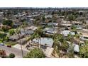 An aerial view of a residential area with lush trees and foliage, highlighting a home with a private pool at 4134 N 35Th St, Phoenix, AZ 85018