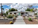 Inviting single-story home with a well-manicured yard, desert landscaping, and a charming walkway to the entrance at 4134 N 35Th St, Phoenix, AZ 85018