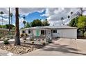 Attractive single-story house with desert landscaping, palm trees, and a welcoming driveway and walkway at 4134 N 35Th St, Phoenix, AZ 85018