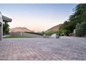 Large stone-paved driveway provides ample parking space and complements the surrounding landscape at 4550 E Foothill Dr, Paradise Valley, AZ 85253