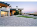 Contemporary home design with a stone driveway and desert landscaping, creating a striking curb appeal at 4550 E Foothill Dr, Paradise Valley, AZ 85253