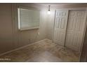 Bedroom with tiled floors, closet with sliding doors, and plenty of natural light at 5201 W Camelback Rd # 181, Phoenix, AZ 85031