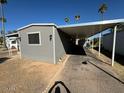 Manufactured home featuring an expansive covered parking area perfect for vehicles or outdoor entertaining at 5201 W Camelback Rd # 181, Phoenix, AZ 85031