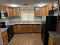 Well-lit kitchen featuring stainless steel appliances, plenty of cabinet space, and neutral countertops at 5201 W Camelback Rd # 181, Phoenix, AZ 85031