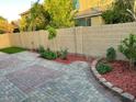 Paver patio bordered by low brick wall and desert landscaping at 61 W Hackberry Dr, Chandler, AZ 85248