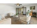 Spacious living room with neutral tones, plush carpet, and views into the dining area at 6217 E El Paso St, Mesa, AZ 85205