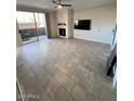 Spacious living room featuring tile flooring, fireplace and sliding door access to an outdoor area at 7009 E Acoma Dr # 1101, Scottsdale, AZ 85254