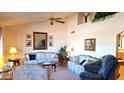 Cozy living room with high ceilings, comfortable seating, and a ceiling fan for added comfort at 8335 E Monte Ave, Mesa, AZ 85209