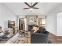 Comfortable living room features a fireplace, neutral colors, balcony access, and dark wood floors at 9396 E Purdue Ave # 220, Scottsdale, AZ 85258